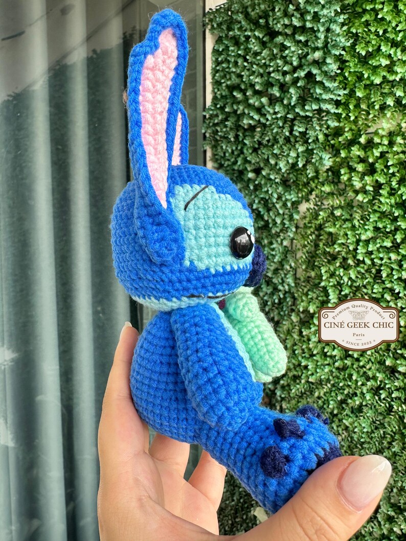 Bring home a fan-favorite duo with this handmade crochet Stitch and Scrump-inspired doll set! Carefully handcrafted with love and soft acrylic yarn, this adorable pair captures the charm of everyone's favorite blue alien and his stitched-up bestie.

Perfect as a collectible, a heartfelt gift for a Stitch lover, or a whimsical piece of decor. Each doll is crafted with attention to detail, from Stitch's signature big ears to Scrump’s button eye and sweet expression. Experiment 626 !
