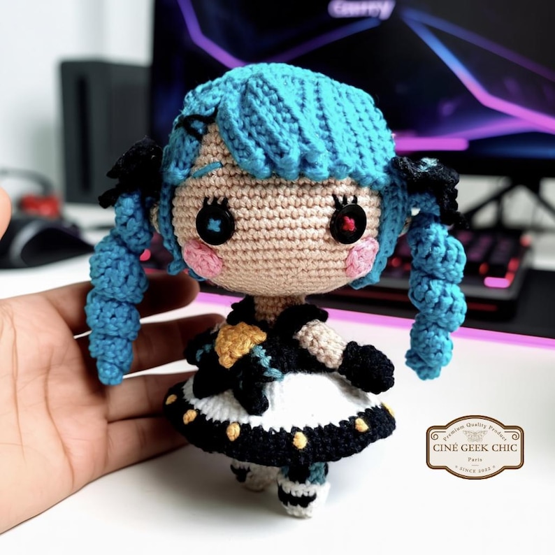 ✂️🧵 Bring the magic of threads and scissors to life with this Gwen-inspired crochet plush, a handmade tribute to the seamstress champion from League of Legends.

Crafted in two options — a 6-inch doll for your desk or display shelf, and a tiny 3-inch keychain for your bag, keys, or car — this doll features Gwen’s signature blue hair, doll-like eyes, and iconic outfit details. A whimsical and elegant gift for any LoL fan!
