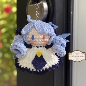 ✂️🧵 Bring the magic of threads and scissors to life with this Gwen-inspired crochet plush, a handmade tribute to the seamstress champion from League of Legends.

Crafted in two options — a 6-inch doll for your desk or display shelf, and a tiny 3-inch keychain for your bag, keys, or car — this doll features Gwen’s signature blue hair, doll-like eyes, and iconic outfit details. A whimsical and elegant gift for any LoL fan!