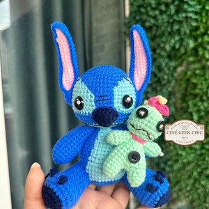 Bring home a fan-favorite duo with this handmade crochet Stitch and Scrump-inspired doll set! Carefully handcrafted with love and soft acrylic yarn, this adorable pair captures the charm of everyone's favorite blue alien and his stitched-up bestie.

Perfect as a collectible, a heartfelt gift for a Stitch lover, or a whimsical piece of decor. Each doll is crafted with attention to detail, from Stitch's signature big ears to Scrump’s button eye and sweet expression. Experiment 626 !