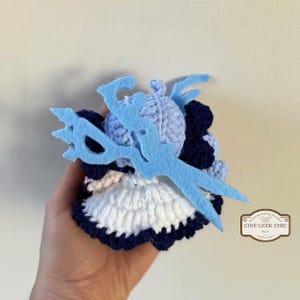 ✂️🧵 Bring the magic of threads and scissors to life with this Gwen-inspired crochet plush, a handmade tribute to the seamstress champion from League of Legends.

Crafted in two options — a 6-inch doll for your desk or display shelf, and a tiny 3-inch keychain for your bag, keys, or car — this doll features Gwen’s signature blue hair, doll-like eyes, and iconic outfit details. A whimsical and elegant gift for any LoL fan!