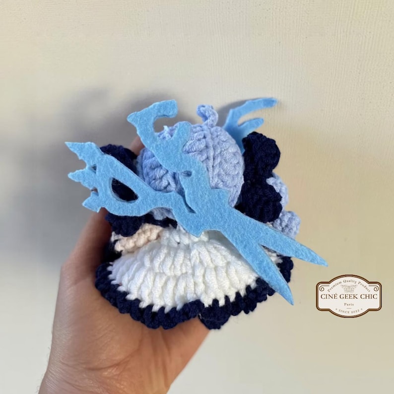 ✂️🧵 Bring the magic of threads and scissors to life with this Gwen-inspired crochet plush, a handmade tribute to the seamstress champion from League of Legends.

Crafted in two options — a 6-inch doll for your desk or display shelf, and a tiny 3-inch keychain for your bag, keys, or car — this doll features Gwen’s signature blue hair, doll-like eyes, and iconic outfit details. A whimsical and elegant gift for any LoL fan!