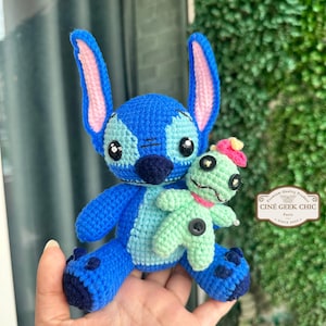 Bring home a fan-favorite duo with this handmade crochet Stitch and Scrump-inspired doll set! Carefully handcrafted with love and soft acrylic yarn, this adorable pair captures the charm of everyone's favorite blue alien and his stitched-up bestie.

Perfect as a collectible, a heartfelt gift for a Stitch lover, or a whimsical piece of decor. Each doll is crafted with attention to detail, from Stitch's signature big ears to Scrump’s button eye and sweet expression. Experiment 626 !