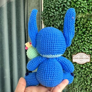 Bring home a fan-favorite duo with this handmade crochet Stitch and Scrump-inspired doll set! Carefully handcrafted with love and soft acrylic yarn, this adorable pair captures the charm of everyone's favorite blue alien and his stitched-up bestie.

Perfect as a collectible, a heartfelt gift for a Stitch lover, or a whimsical piece of decor. Each doll is crafted with attention to detail, from Stitch's signature big ears to Scrump’s button eye and sweet expression. Experiment 626 !