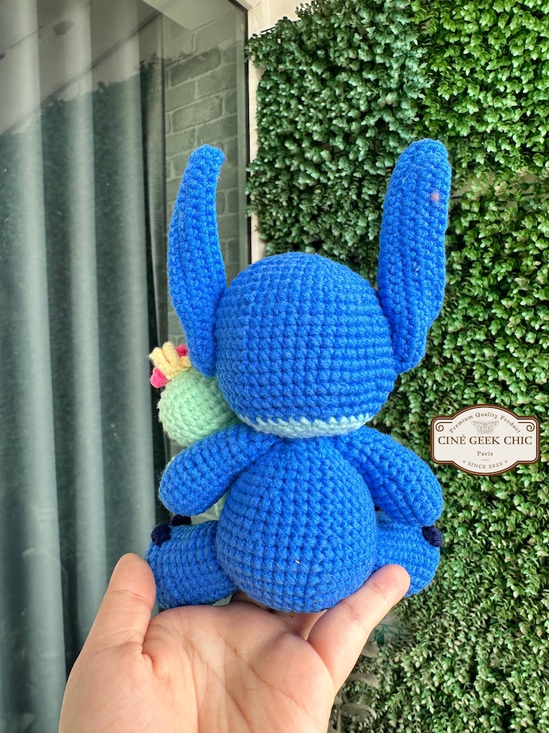 Bring home a fan-favorite duo with this handmade crochet Stitch and Scrump-inspired doll set! Carefully handcrafted with love and soft acrylic yarn, this adorable pair captures the charm of everyone's favorite blue alien and his stitched-up bestie.

Perfect as a collectible, a heartfelt gift for a Stitch lover, or a whimsical piece of decor. Each doll is crafted with attention to detail, from Stitch's signature big ears to Scrump’s button eye and sweet expression. Experiment 626 !