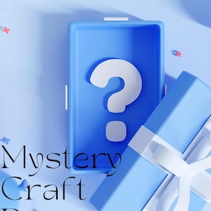 May include: A blue box with a white question mark inside, partially open to reveal a blue gift box with a white ribbon. The text "Mystery Craft Box" is written in black on a white background.