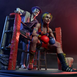 May include: A detailed figurine of a female boxer in a red and blue outfit, seated in a boxing ring. She wears red and blue boxing gloves and tall black boots. The Joker stands behind her, leaning on the ring ropes.