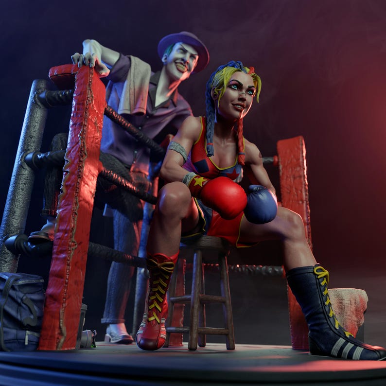 May include: A detailed figurine of a female boxer in a red and blue outfit, seated in a boxing ring. She wears red and blue boxing gloves and tall black boots. The Joker stands behind her, leaning on the ring ropes.