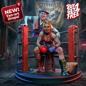 May include: A detailed fan-art statue of two comic book characters in a boxing ring. One character is seated, wearing boxing gloves and gear. The other character is standing behind, leaning on the ring's ropes. The ring is red and the background has a banner that says "Gotham".