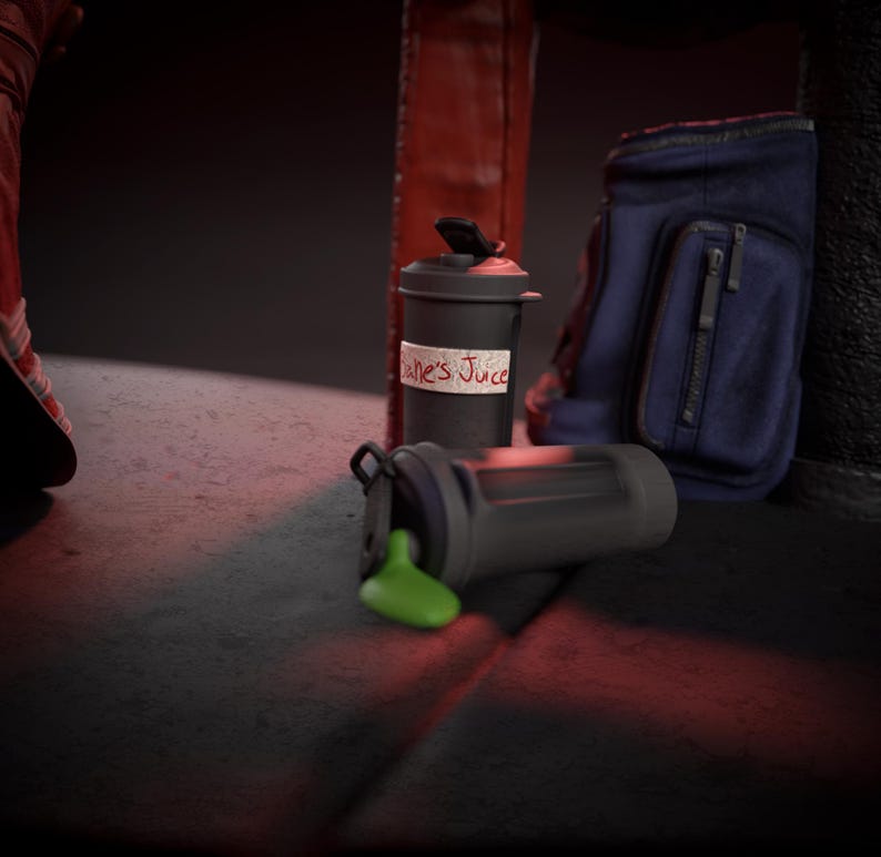 May include: A black and grey shaker bottle with green liquid spilled out, next to a matching shaker bottle with a label that reads "Jane's Juice". A blue gym bag is in the background.