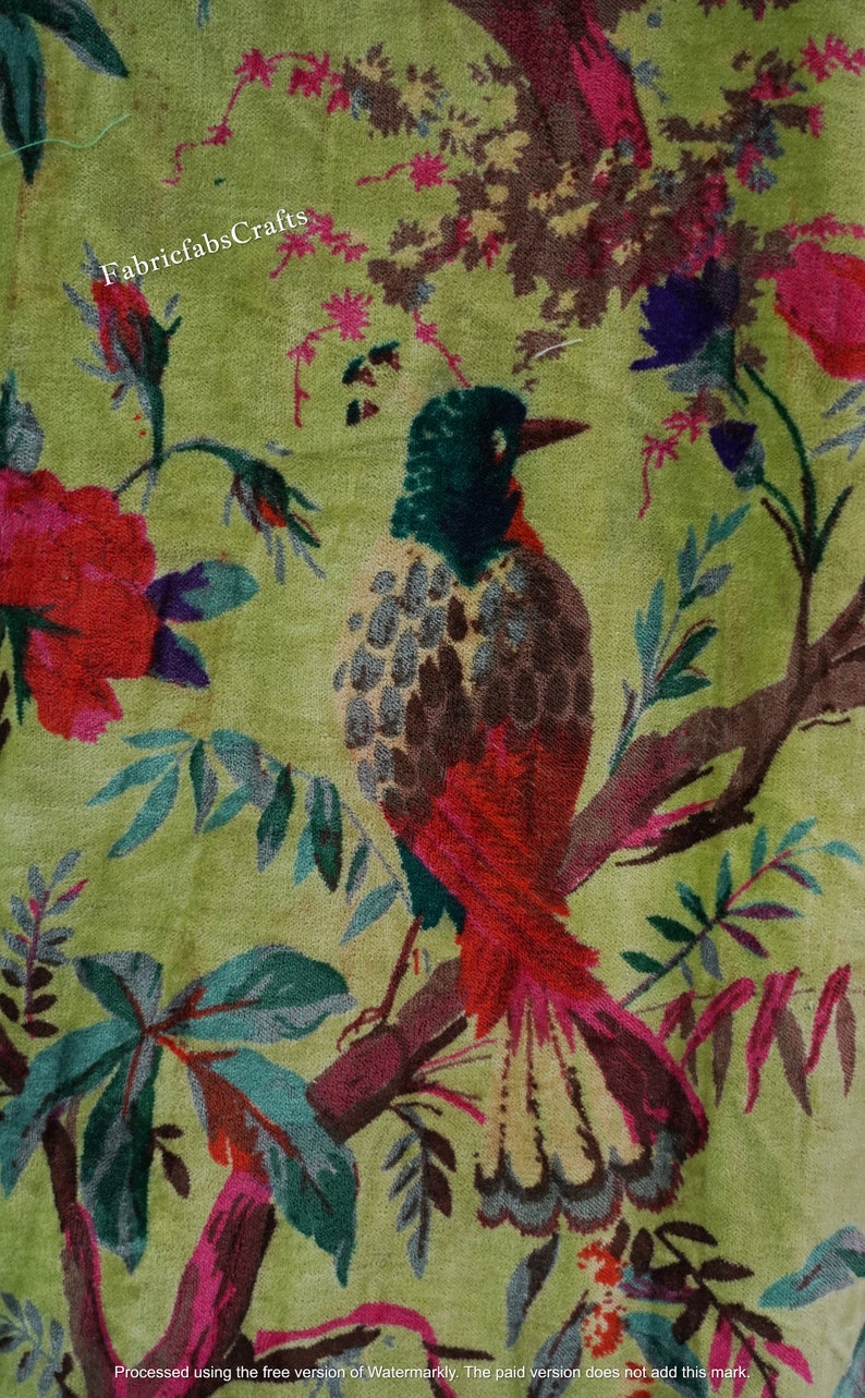 May include: A green velvet fabric with a floral pattern featuring red, pink, and purple flowers, green leaves, and a brown and red bird with a long tail.