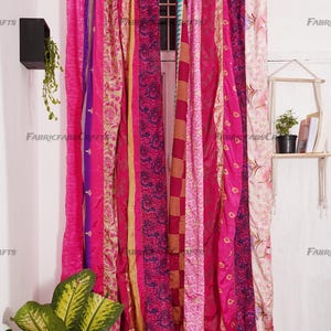 Puede incluir: Un conjunto de cortinas de tela rosa y p&uacute;rpura con una variedad de patrones. Las cortinas est&aacute;n hechas de saris reciclados y son perfectas para agregar un toque de estilo bohemio a cualquier habitaci&oacute;n.