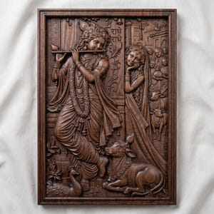 May include: A rectangular dark brown wooden wall plaque featuring a detailed relief carving of Krishna playing a flute, accompanied by Radha, a cow, and a peacock. The Hindi text "राधे राधे" is inscribed in the upper right section of the panel.