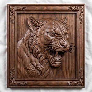 May include: A dark brown wooden wall plaque featuring a high-relief carving of a snarling tiger head. The tiger is depicted with bared teeth and detailed fur texture. The piece is enclosed in a rectangular frame with ornate corner scrollwork.