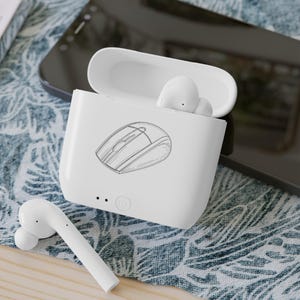 May include: White wireless earbuds with a charging case. The case has a sketch of a computer mouse on the front. One earbud is outside the case, and two are inside. The case is open, and the earbuds are white.