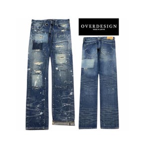 May include: Blue denim jeans featuring a distressed finish with multiple rectangular patches, white paint splatters, and frayed edges. The front displays a button fly and metal ring, while the back shows two pockets and a tan leather patch. Text reads OVERDESIGN MADE IN JAPAN.