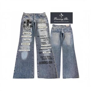 May include: Light blue denim jeans with a wide-leg silhouette, featuring black graphic text prints and rectangular patches with text. The front displays various phrases and a cross logo, while the back shows two pockets. Includes a brand tag reading Pemning Sho.