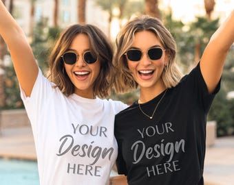 May include: Two people wearing sunglasses and t-shirts. One shirt is white, the other is black. Both shirts have the text "YOUR Design HERE" in a script font. The background is blurred, with palm trees visible.