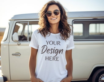 May include: A white t-shirt with the text "YOUR Design HERE" in a script font. The model is wearing sunglasses and standing in front of a vintage white van. The shirt has short sleeves and a crew neck.