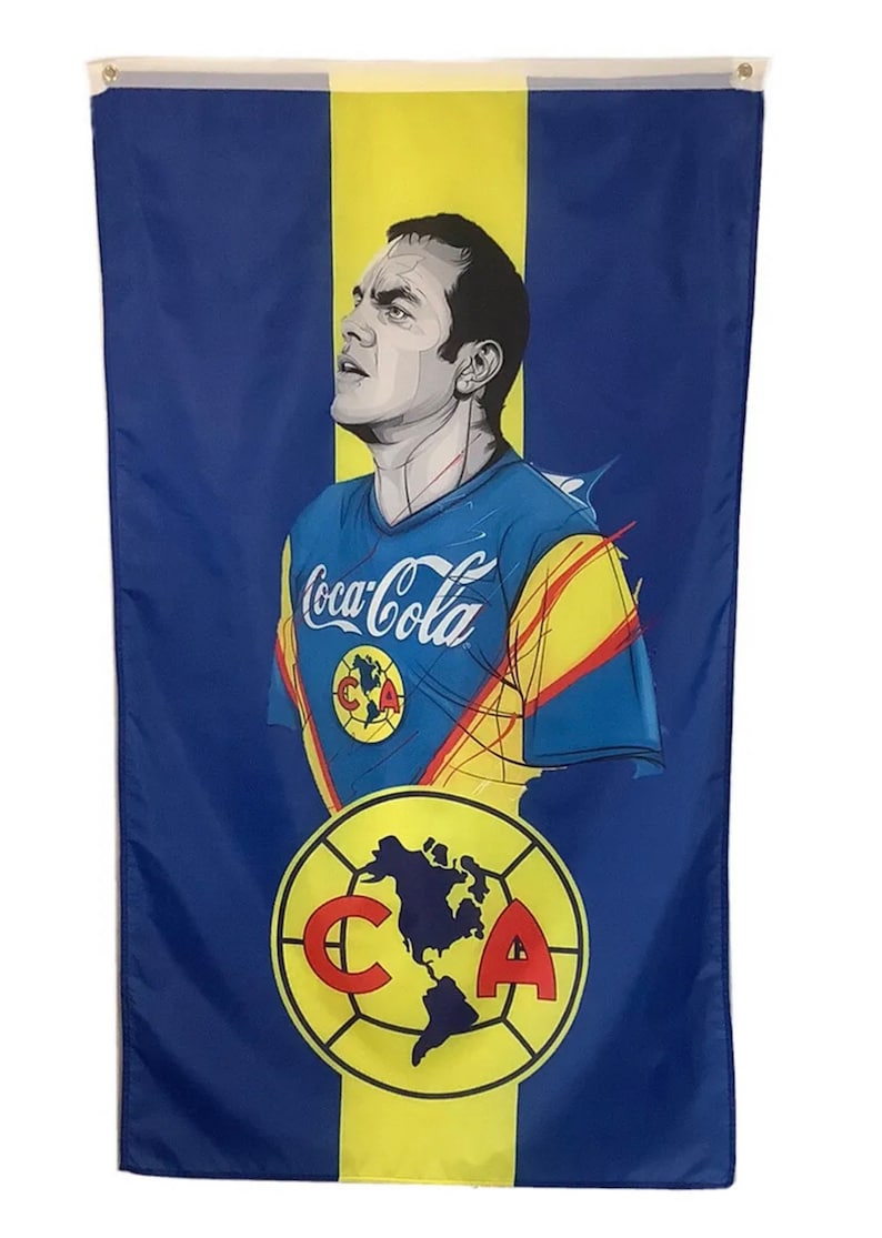 May include: A blue and yellow flag with a portrait of a soccer player wearing a blue and yellow jersey with the Coca-Cola logo. The flag also features a yellow circle with a soccer ball and the letters "C" and "A" in red.