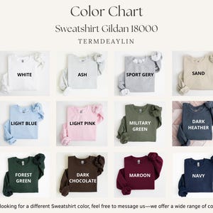 K&ouml;nnte beinhalten: Farbkarte mit Gildan 18000 Sweatshirts in verschiedenen Farben, darunter Wei&szlig;, Aschgrau, Sportgrau, Sand, Hellblau, Hellrosa, Milit&auml;rgr&uuml;n, Dunkelgrau, Waldgr&uuml;n, Dunkelbraun, Bordeauxrot und Marineblau. Der Text "TERMDEAYLIN" ist ebenfalls sichtbar.