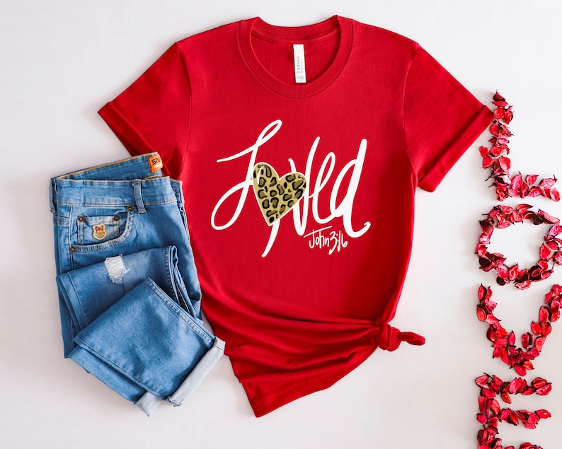 May include: Red t-shirt with a white graphic that says "Loved" with a leopard print heart and the text "John 3:16".