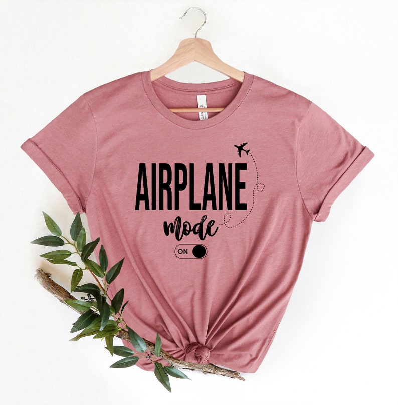 May include: A mauve t-shirt with the text "AIRPLANE mode ON" and a small airplane graphic.