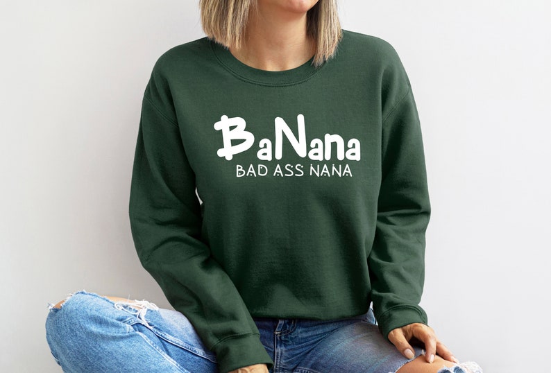 May include: A dark green sweatshirt with the text "BaNana BAD ASS NANA" in white.