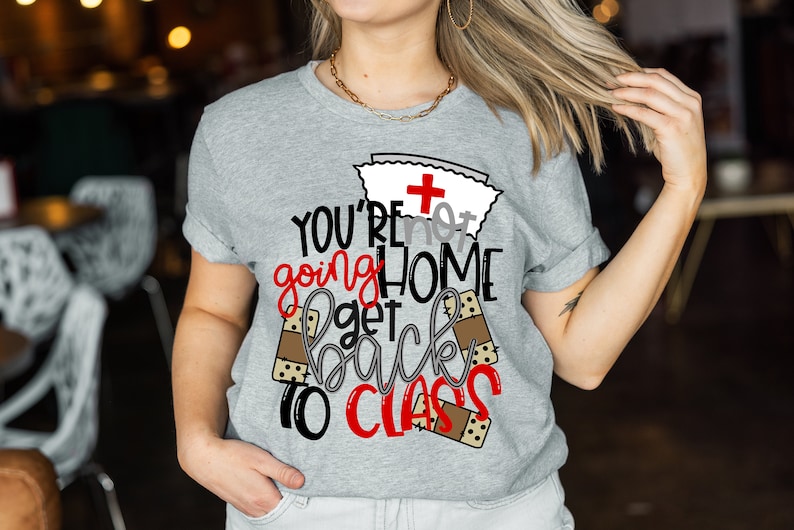 May include: Gray t-shirt with a red cross and the text "YOU'RE not going HOME get back to CLASS" with brown bandage graphics.