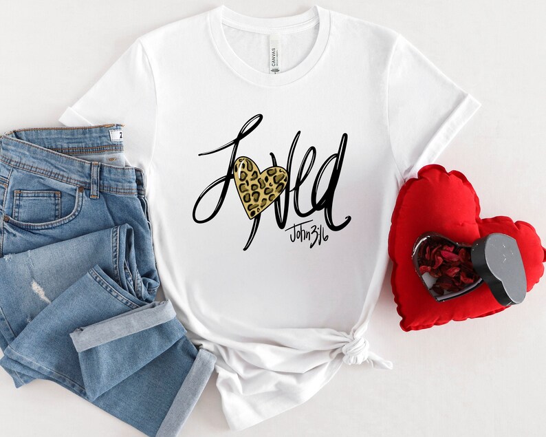 May include: White t-shirt with a black and gold leopard print heart and the text "Loved" with "John 3:16" underneath.