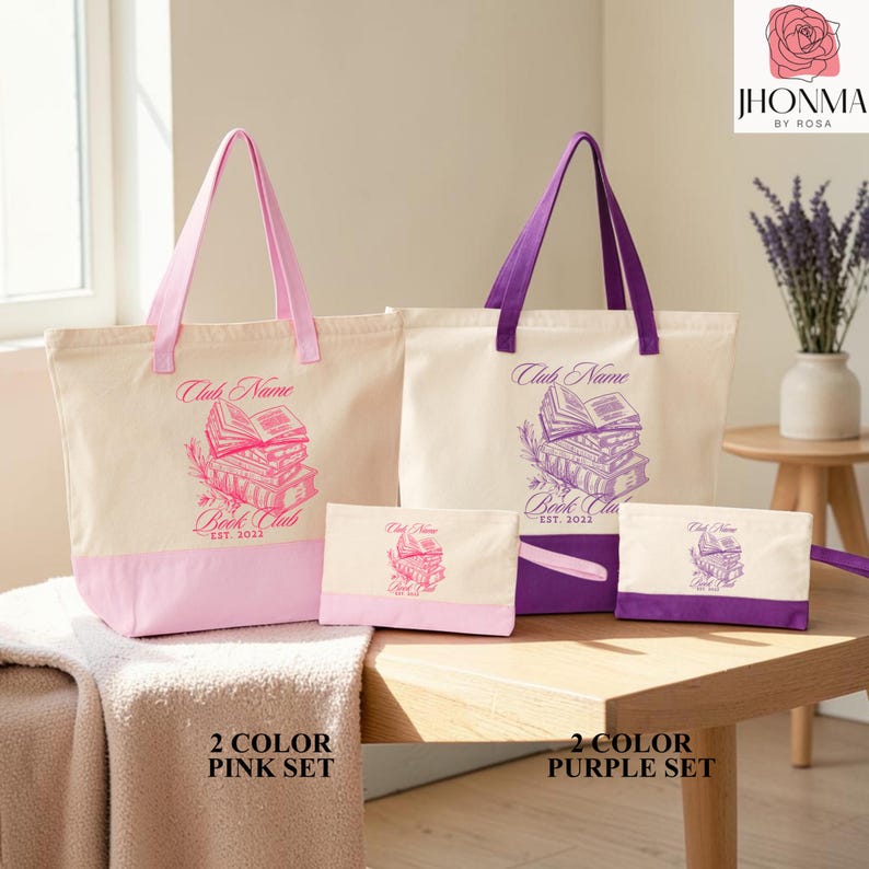 A set of two tote bags and a small pouch, each with a unique design, placed on a wooden table. The bags are pink and purple, and the pouch is purple. The image also includes text that reads "Club Name" and "Book Club" along with the year "2012".