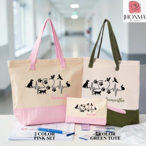 May include: Two canvas tote bags and a matching pouch featuring a black heartbeat graphic with animal silhouettes including a dog, cat, squirrel, bird, and rabbit, plus paw prints. One tote has pink handles and base, the other has olive green accents.