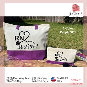 May include: A two-piece tote bag and cosmetic bag set in a purple and white color scheme. The tote bag and cosmetic bag feature a black and white design of a stethoscope and the letters "RN" with the name "Michelle" underneath. The set is labeled "2 Color Purple Set".