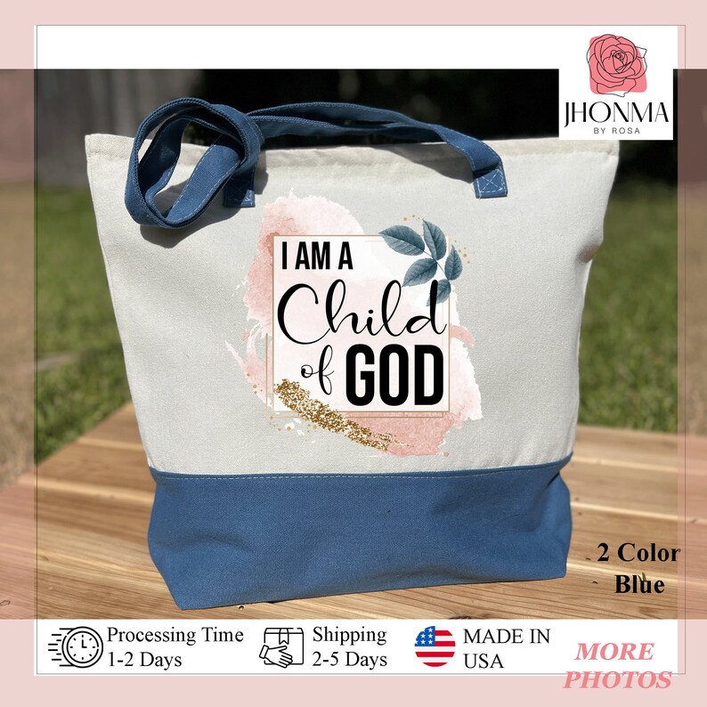 May include: A white canvas tote bag with blue handles and a blue bottom. The bag has a pink and white watercolor design with gold glitter and the text "I AM A Child of GOD".