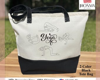 May include: White canvas tote bag with black handles and a black bottom. The bag has a black and white line drawing of four yoga poses and the word "Yoga" in a stylized font. The bag also has the text "JHONMA BY ROSA" and "2 Color Black Tote Bag" printed on it.