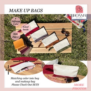 May include: Eight different color makeup bags with zippers and lined interiors. The bags are 9.75 inches wide and 6 inches tall. The bags are displayed on a wooden surface with a green grassy background. The text "MAKE UP BAGS" is at the top of the image. The text "JHONMA BY ROSA" is in the upper right corner of the image. The text "Matching color tote bag and makeup bag Please Check Out SETS" is at the bottom of the image.