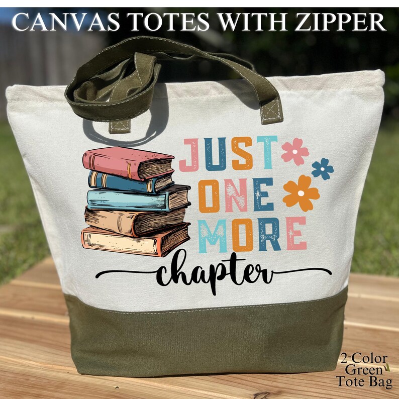 May include: A canvas tote bag with a zipper, featuring a design with stacked books and the text "JUST ONE MORE chapter." The bag has a white upper section, a green bottom, and green handles. The words "2-Color Green Tote Bag" are also visible.