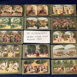 May include: A collection of 14 vintage lithographs featuring scenes from Japan, China, India, Algiers, and Java. The images are in color and depict various cultural settings and landscapes. The lithographs are mounted on green cardstock.