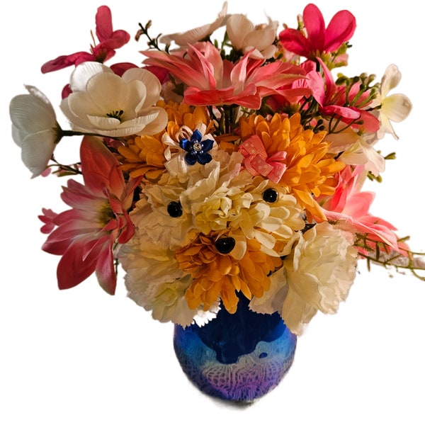 Faux Silk Flower Arrangement of Small Tan and White Puppy with Pretty Bows sitting in a Glass