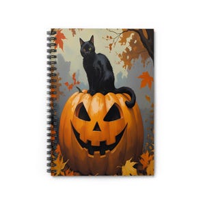 Può includere: Quaderno a spirale con un'illustrazione di Halloween. Un gatto nero con occhi gialli è seduto su una zucca arancione intagliata. Lo sfondo include foglie autunnali e un albero, creando una scena autunnale festosa.
