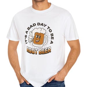 May include: White t-shirt with a cartoon root beer mug and the text "It's a bad day to be a root beer".