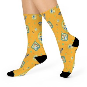 May include: A pair of yellow socks with a pattern of colorful cells and DNA strands. The socks are made of a soft, comfortable material and are perfect for everyday wear.