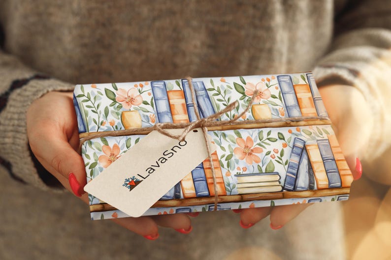 May include: A gift wrapped in white paper with a floral and book pattern. The paper is tied with twine and a brown tag with the text "LavaSno" printed on it.
