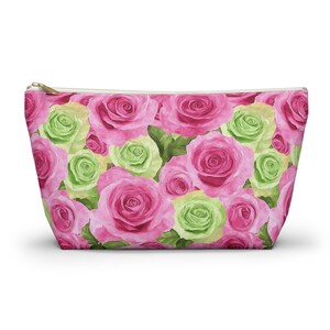 May include: A pink and green floral print cosmetic bag with a zipper closure. The bag is filled with pink and green roses.