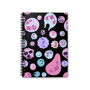 May include: A black spiral notebook with a colorful pattern of pink, purple, and blue cells on the cover.