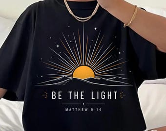 Be The Light Bible Verse Graphic Tee Comfort Colors Shirt With Celestial Sun Over Mountains Aesthetic Boho Christian Spiritual Gift For Her