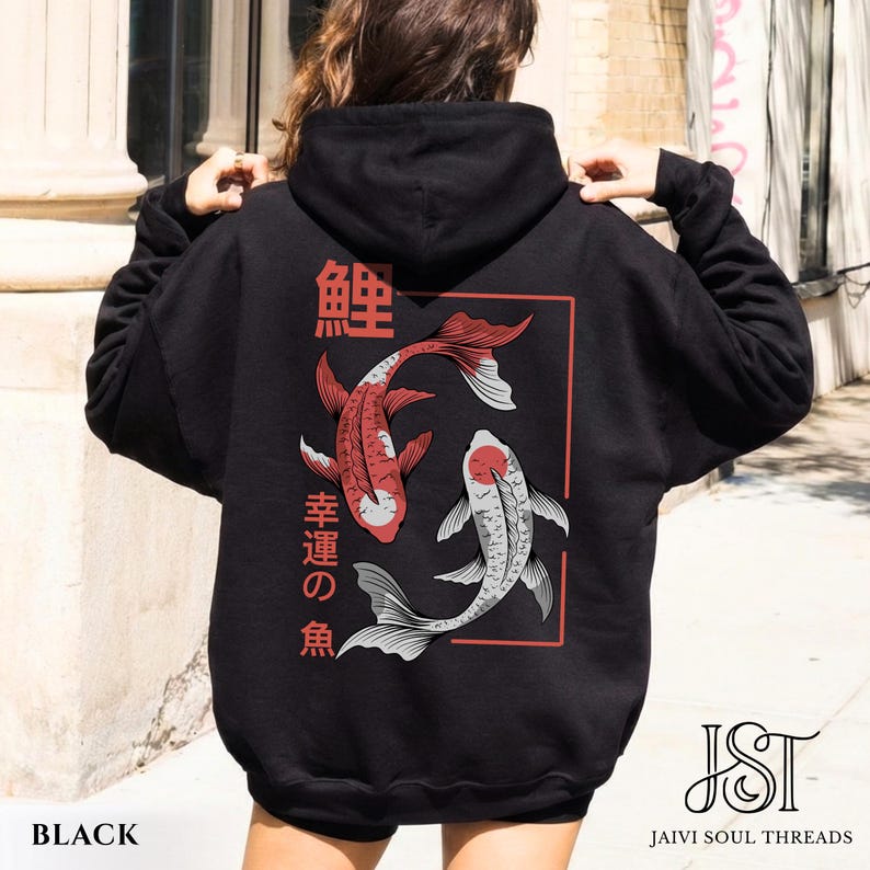 May include: Black hoodie featuring a red and white koi fish design with Japanese text. The graphic is framed in a red rectangle. The hoodie has a drawstring hood and long sleeves. The text "BLACK" is at the bottom.