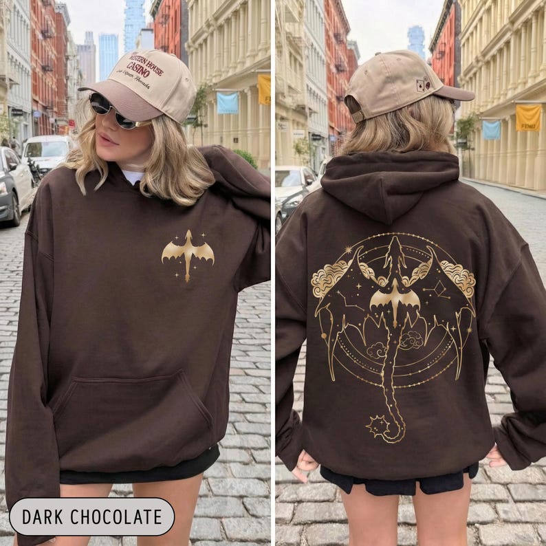 May include: Dark chocolate brown hoodie with a gold dragon graphic on the front and back. The front features a small dragon design, while the back showcases a larger, detailed dragon illustration with celestial elements. The text "DARK CHOCOLATE" is at the bottom.