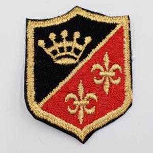 May include: A black and red embroidered patch with a gold crown and two gold fleurs-de-lis.