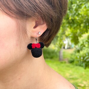 May include: Crocheted black and red Minnie Mouse earrings with silver hooks.